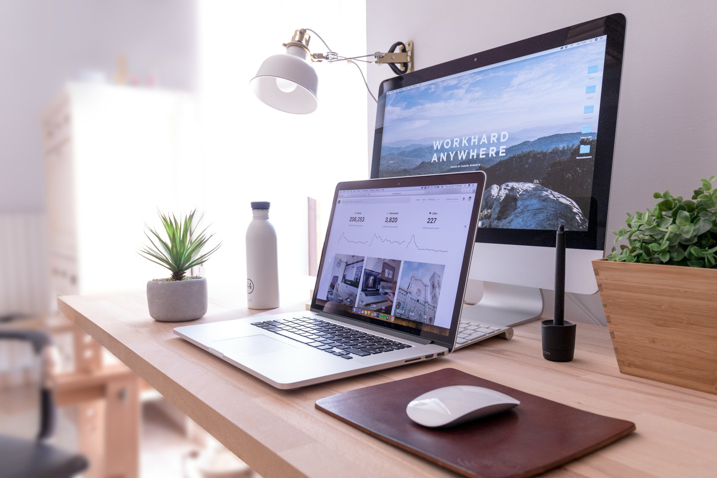 Laptop and monitor on a tidy wooden desk
